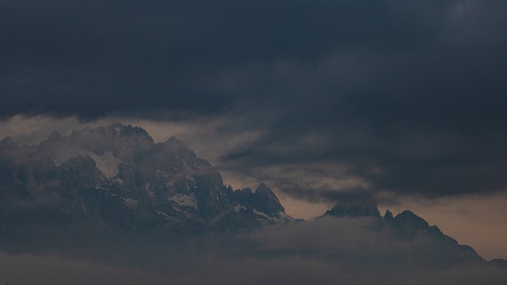 Snowy peaks wrapped in heavy cloud