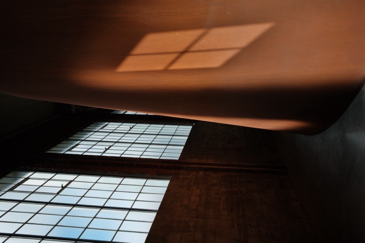 Window light falling across a curved interior wall