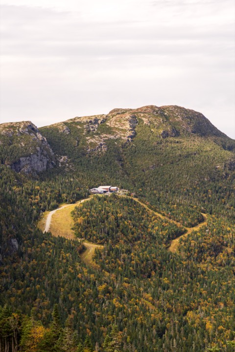 Mountain lodge amid early autumn slopes