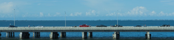 Pier stretching across a calm blue bay