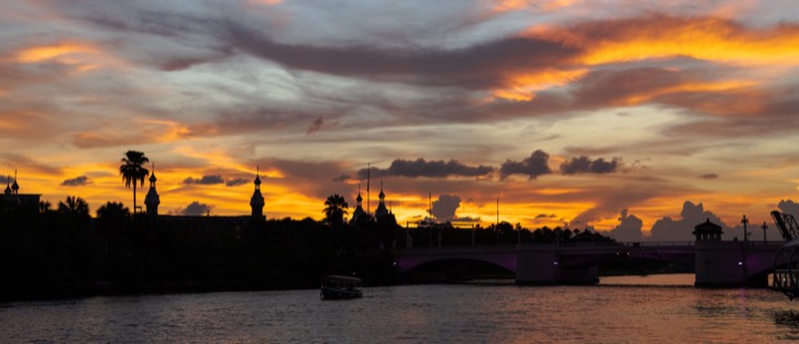 Vivid orange sunset over a river and bridge